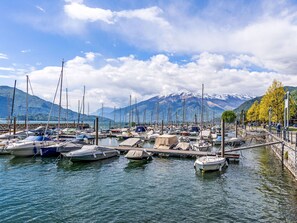 A marina with boats docked, a dock, and a mountainous backdrop. - La Baita dei Nonni by Interhome (Gera Lario)