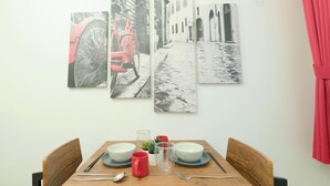 A dining table with plates, bowls, a red mug, and cutlery. - Fuente Nishi Sugamo by Tranova 2 (Toshima)