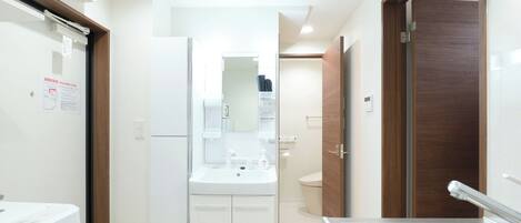 A modern kitchen with a built-in oven, a sink, and a refrigerator.