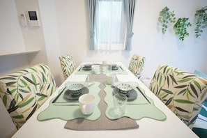 A dining area with a long table, chairs, and a window with curtains. - G-stage 01 IKEBUKURO 2 by Tranova (Toshima)