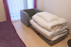 A room with a bed, a grey armchair, and a window with sheer curtains. - G-stage 01 IKEBUKURO 2 by Tranova (Toshima)