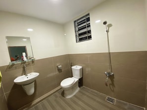 A bathroom with a sink, toilet, and shower.