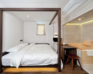 A bedroom with a bed, a desk, and a bathroom. - whalero (Seoul)