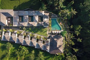 An aerial view of a resort with multiple buildings, a swimming pool, and a well-maintained garden. - Sarva Ubud Villas & Spa (Ubud)