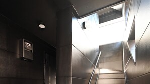 A staircase with metal railings and a tiled floor, leading to a higher level. - Stylewood Nishi-Shinjuku 2 (Shibuya)