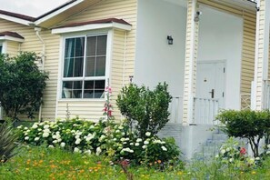 A house with a front porch, a window, and a door.