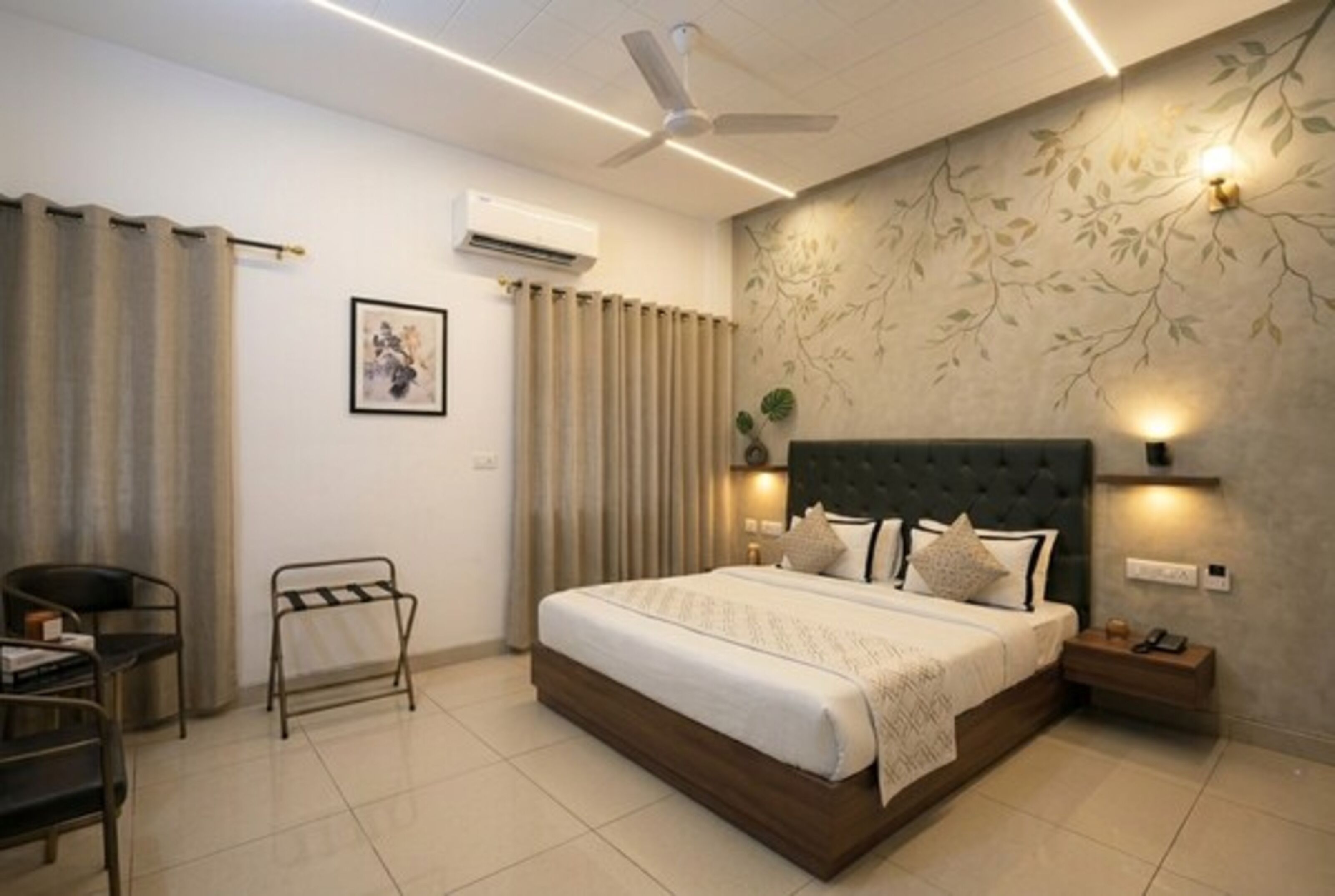A modern bedroom with a bed, a chair, a nightstand, an air conditioner, and a ceiling fan.