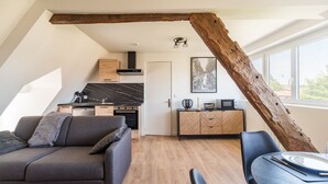 A modern loft with a kitchen, dining area, and living space.