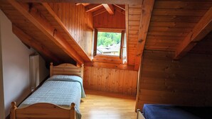 A small, wooden room with two beds and a window. - Apartment 12 Maso Anna (Mastellina)