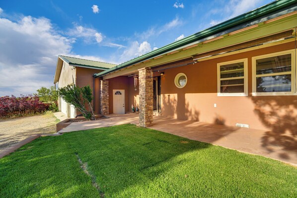 A house with a well-maintained lawn, a front porch, and a garage.