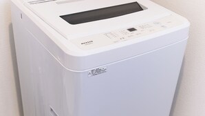 A compact, white, wall-mounted laundry machine with a control panel and a transparent door. - Zenith Nishinakanobu 2 (Shinagawa)