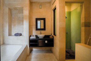 A modern bathroom with a bathtub, a sink, and a mirror. - VILLA NARADA -TROPICAL PARADISE VILLA - PRIVATE POOL - CONVENIENT LOCATION (seminyak)