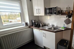 A compact kitchen with a microwave, coffee maker, and sink. - Holiday apartment with 0 bedrooms (Dresden)