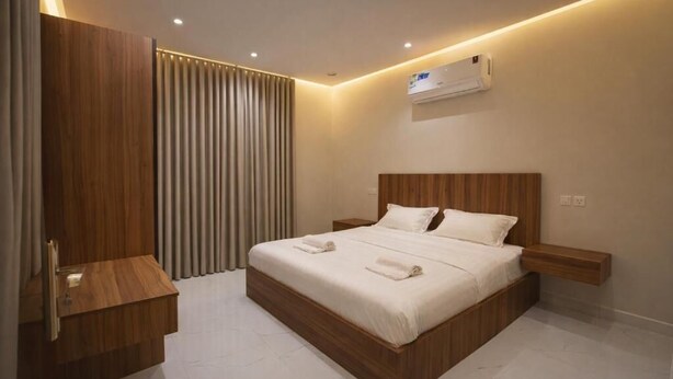 A modern bedroom with a wooden bed frame, white bedding, and a built-in nightstand. - الشقق الفاخره Luxury Apartments (AL Madinah AL Munawwarah)