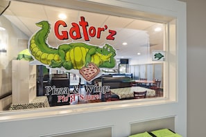 A restaurant window with a cartoon dinosaur and the name 'Gatorz' above it. - Admirals Row, Ocean Front Villa-Hilton Head Beach and Tennis (Hilton Head Island)