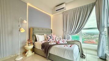 A modern bedroom with a large bed, a bedside table with a lamp, and a view of a cityscape through the window.
