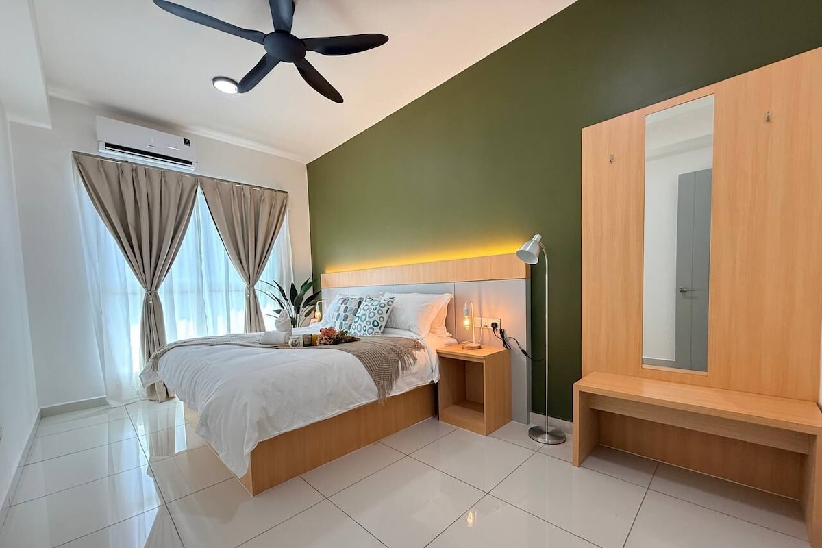 A modern bedroom with a bed, bedside table, lamp, and a large mirror.