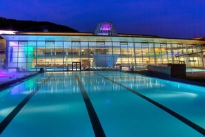 A modern building with a glass facade, a pool, and a distinctive dome structure. - Apartment Mary (4-8 people) (Fürth)