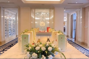 A hotel lobby with a reception desk, a chandelier, and a patterned carpet. - Eclat (Xuyi)
