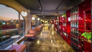 A modern interior with a long corridor, seating areas, and a view through large windows. - Eclat (Xuyi)