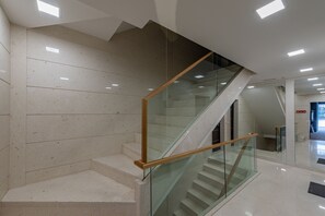 A modern interior with a glass staircase, white walls, and a clean, minimalist design. - Zaria Luxury Residence (Zadar)