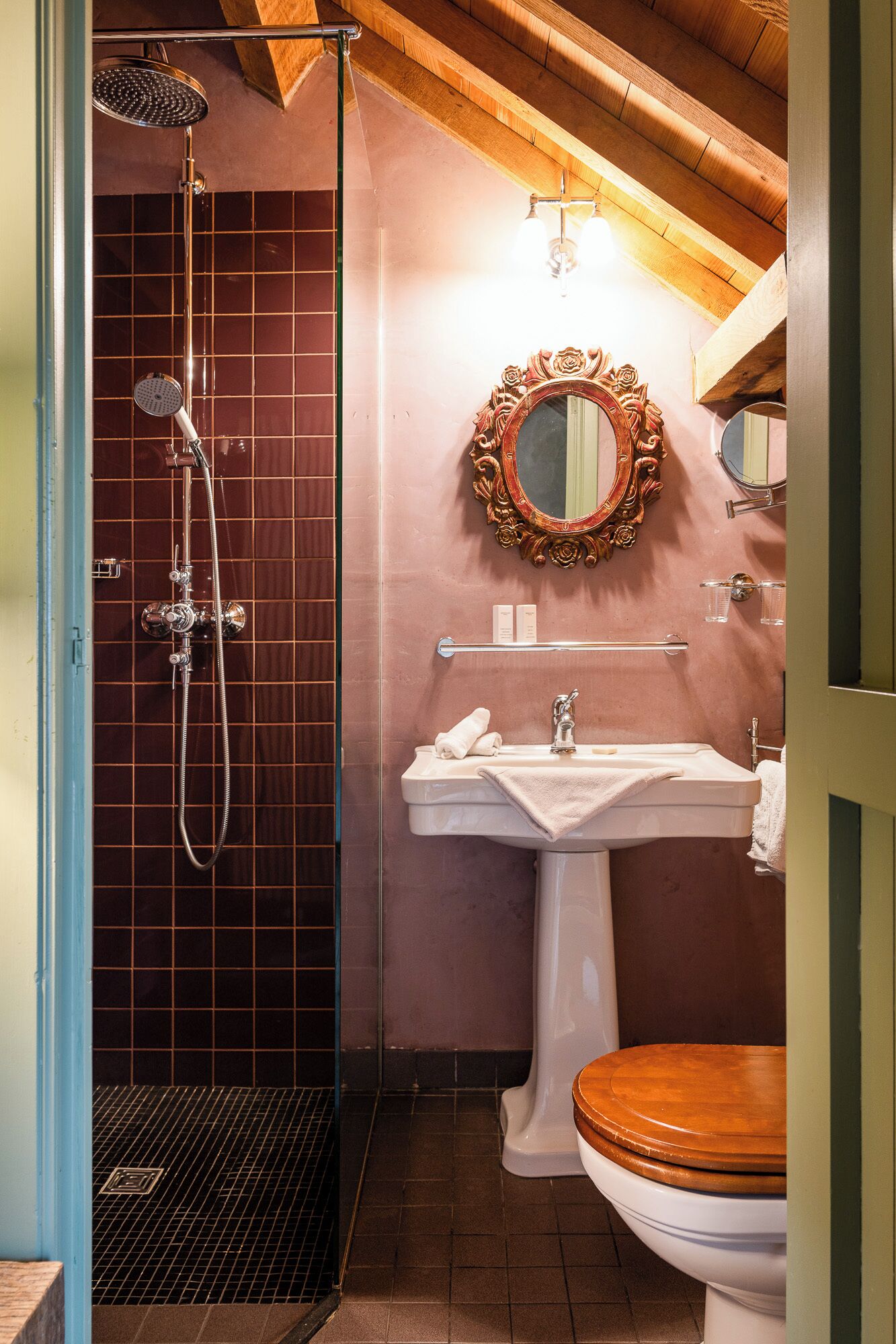 A bathroom with a shower, sink, and toilet.