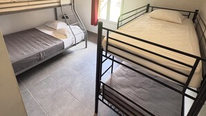 A dormitory room with two bunk beds, a window with curtains, and a ceiling light. - Chalet Douglas - 30 People (Châtillon-Saint-Jean)