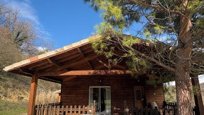 A wooden cabin with a porch, a gravel driveway, and a large tree in front. - Chalet Douglas - 30 People (Châtillon-Saint-Jean)