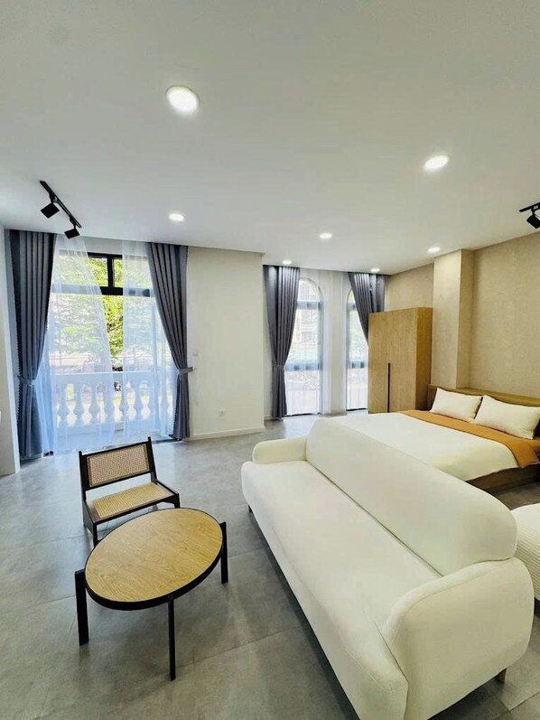 Deluxe Quadruple Room, Balcony, City View | Desk, laptop workspace, soundproofing, free WiFi