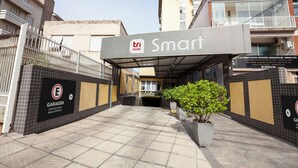 A hotel entrance with a sign reading 'Tri Hotel Smart,' a gated garage area, and tiled flooring. - TRI HOTEL SMART SANTA MARIA (Santa Maria)