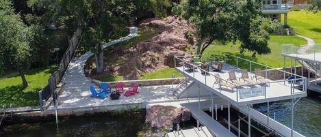 A dock with a deck, chairs, and a sign for nightly rentals.