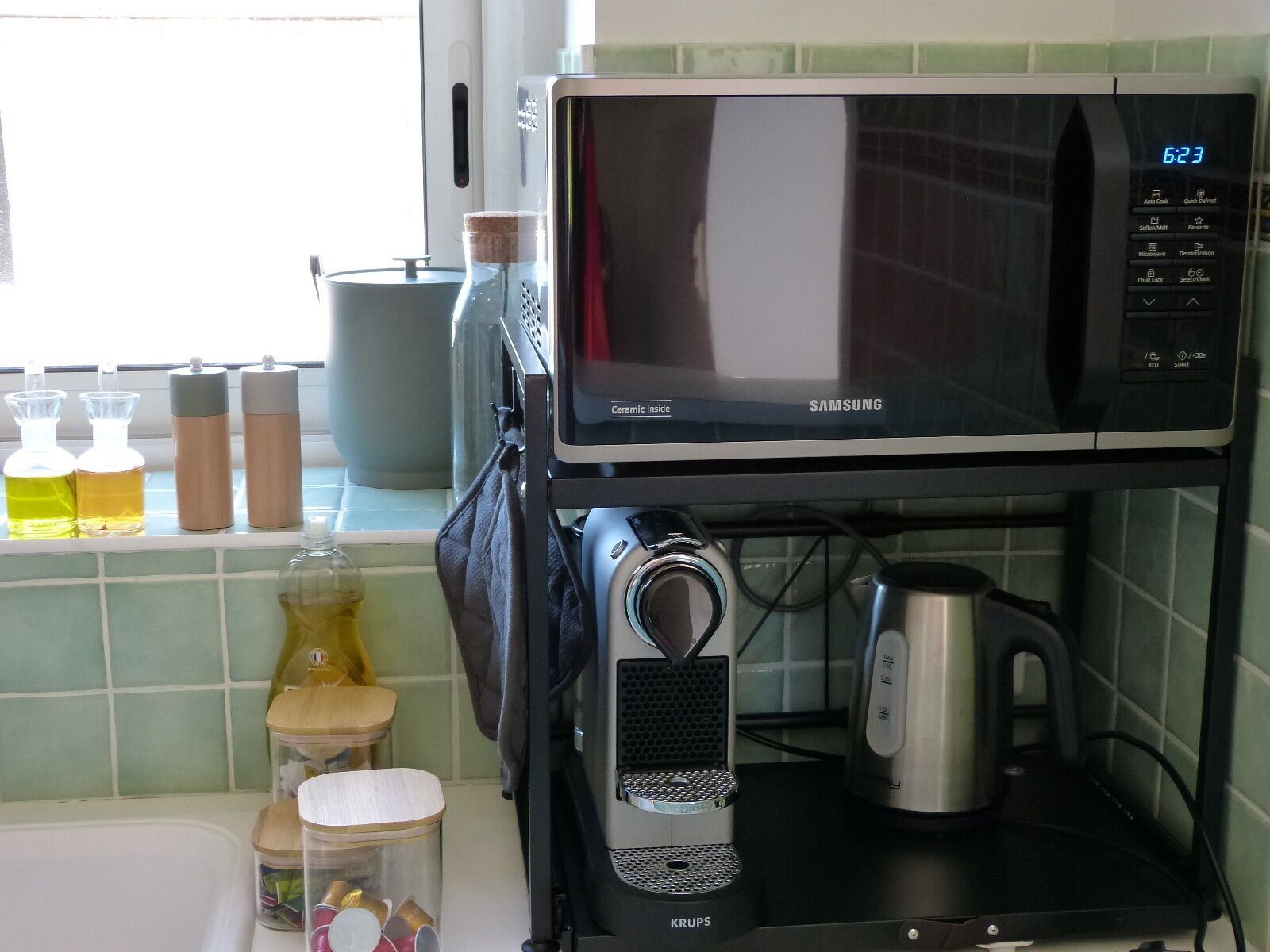 A kitchen with a microwave, coffee maker, and various kitchen items on the counter.
