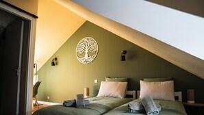 A room with two beds, a tree-shaped wall decoration, and a sloped ceiling. - Le50300 Gîte for 5 pers in Avranches, close to Mont Michel ! (Avranches)