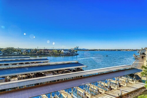 Waterfront condo with furnished balcony, central AC, & washer/dryer
