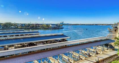Waterfront condo with furnished balcony, central AC, & washer/dryer