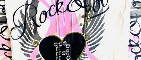 A decorative pillow with the text 'Rock & Love' and a heart-shaped design with the phrase 'I love you' inside.