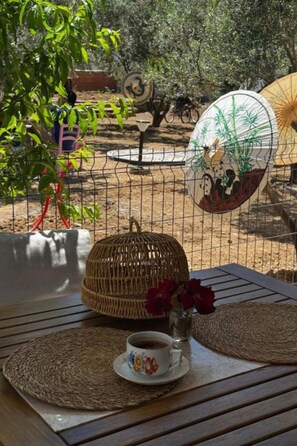 A table with a woven placemat, a cup of coffee, and a decorative plate with bamboo.