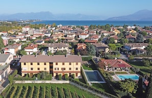 A residential area with houses, a swimming pool, and a view of the sea. - Apollo 19 by Wonderful Italy (Sirmione)