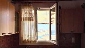 Eine Küche mit Fenster, Spüle und Schränken.
