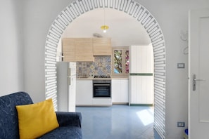 A modern kitchen with white cabinets, a patterned backsplash, and a built-in oven.