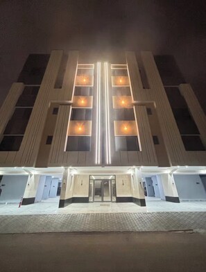 A multi-story hotel with a symmetrical facade, large windows, and a central entrance.