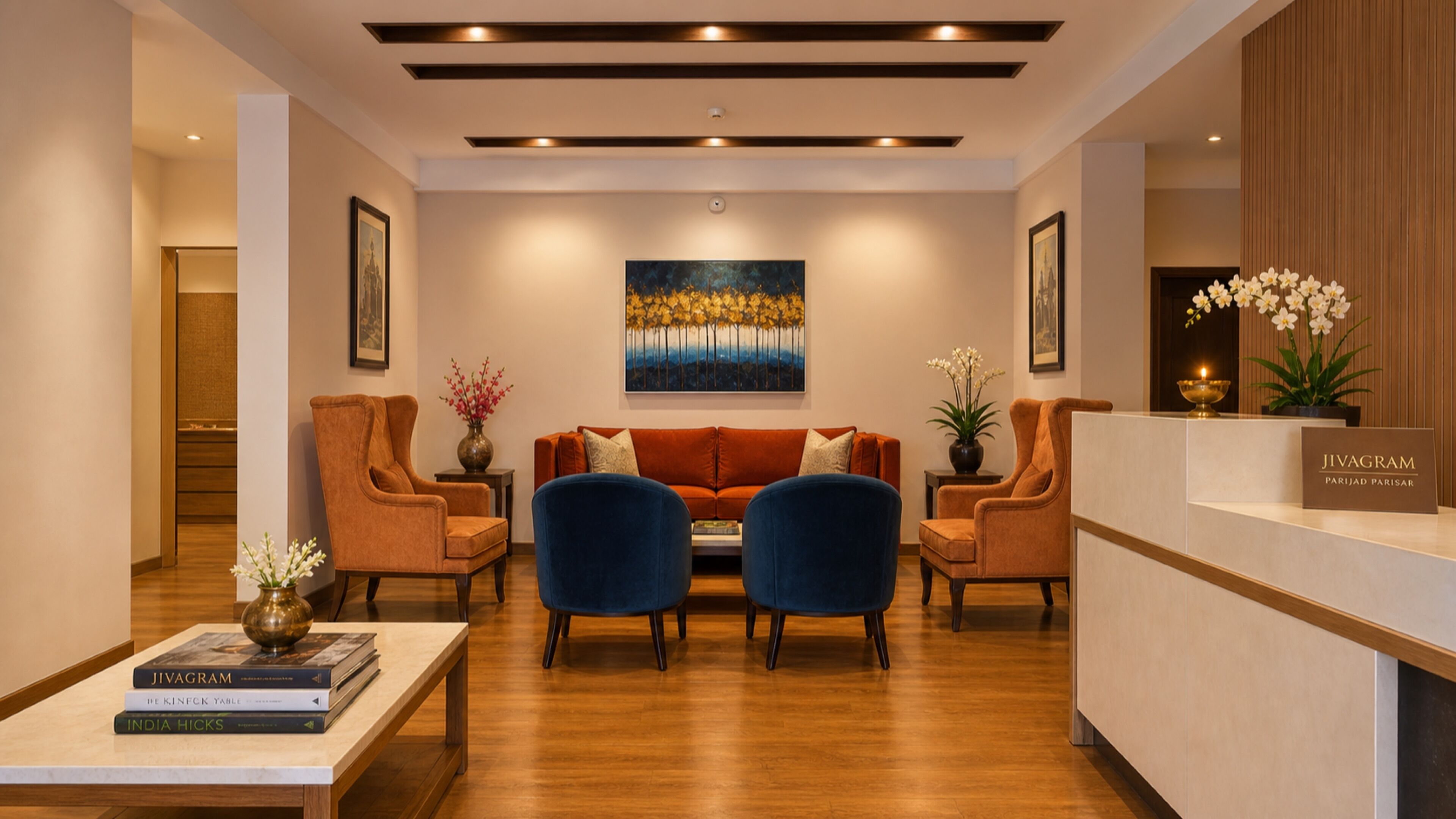 A modern reception area with a reception desk, two sofas, and a coffee table with books.