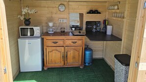 A compact kitchenette with a microwave, coffee maker, and a small refrigerator. - The Mongolian Yurt, an unusual accommodation (Souleuvre en Bocage)