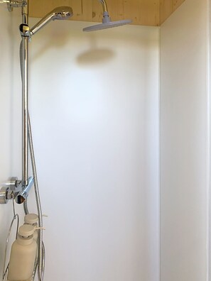A shower with a handheld showerhead and a handheld shower attachment. - The wooden FLOMARIN coco by the sea (Paimpol)
