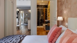 A bedroom with a bed, pillows, a nightstand, and a lamp. - Albero Apartment by Maison Florence (Florence)