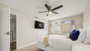 A bedroom with a bed, a ceiling fan, a TV, and a window with a view. - NEW Camelback 352 Resort-style Stay Near Old Town (Scottsdale)