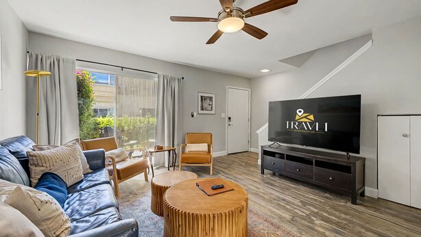 A modern living room with a leather sofa, wooden coffee table, and a ceiling fan. - NEW Camelback 352 Resort-style Stay Near Old Town (Scottsdale)