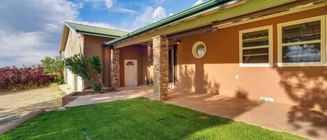 A house with a well-maintained lawn, a front porch, and a garage.