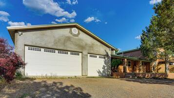 A two-story house with a garage, a front porch, and a driveway.