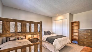 A bedroom with a bunk bed, a single bed, a dresser, and a wardrobe. - Modern Condo w/ Balcony & Bbq, 6 Mi to Winter Park (Fraser)